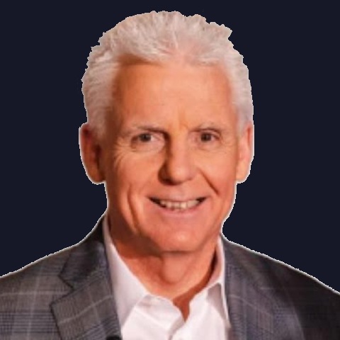 Portrait of Robert Henderson, smiling, in a gray plaid jacket